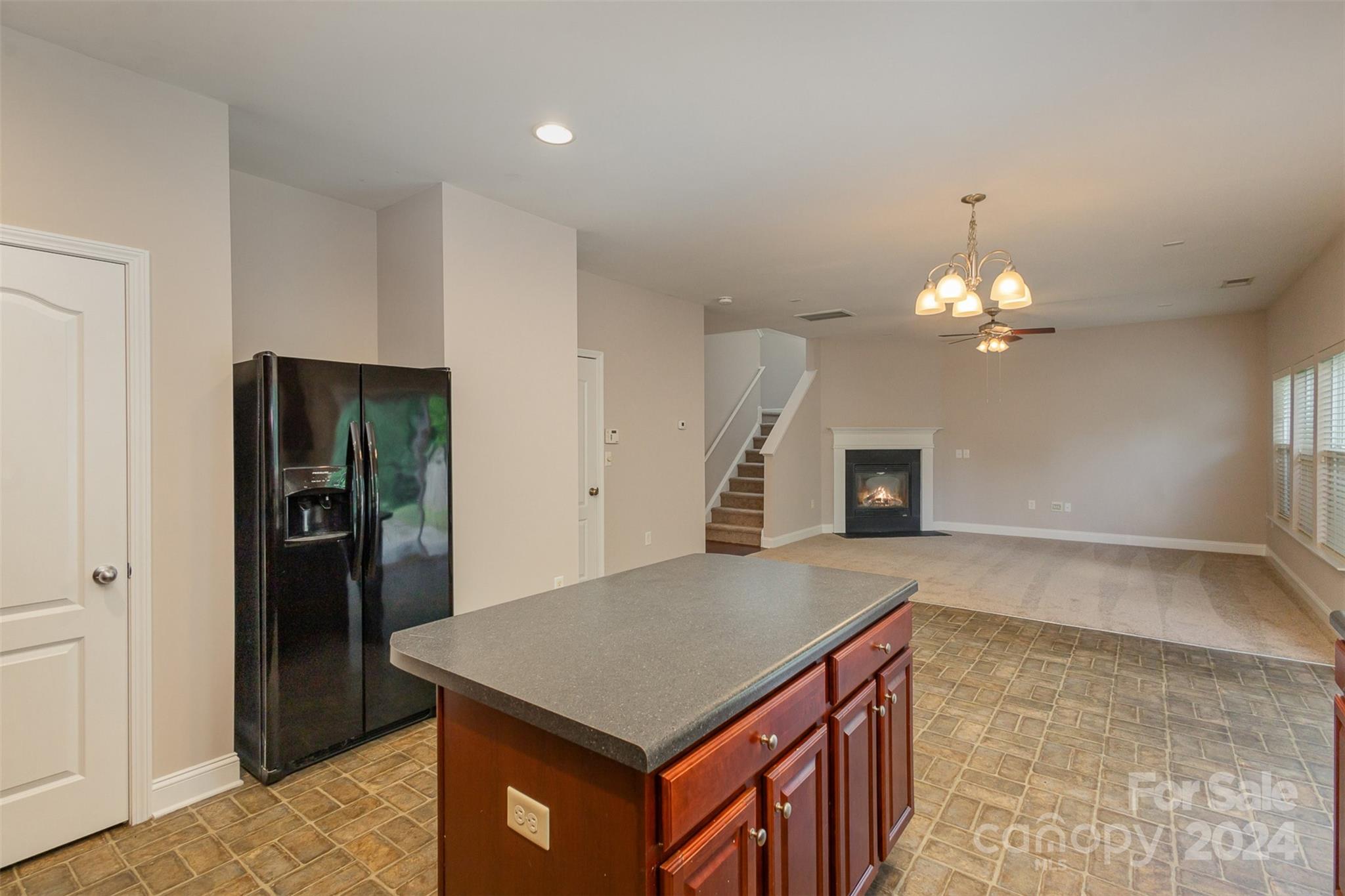 503 Waterlemon Way Monroe, NC 28110 - Photo 8 of 22 a kitchen that has a kitchen island a stove a refrigerator and a sink