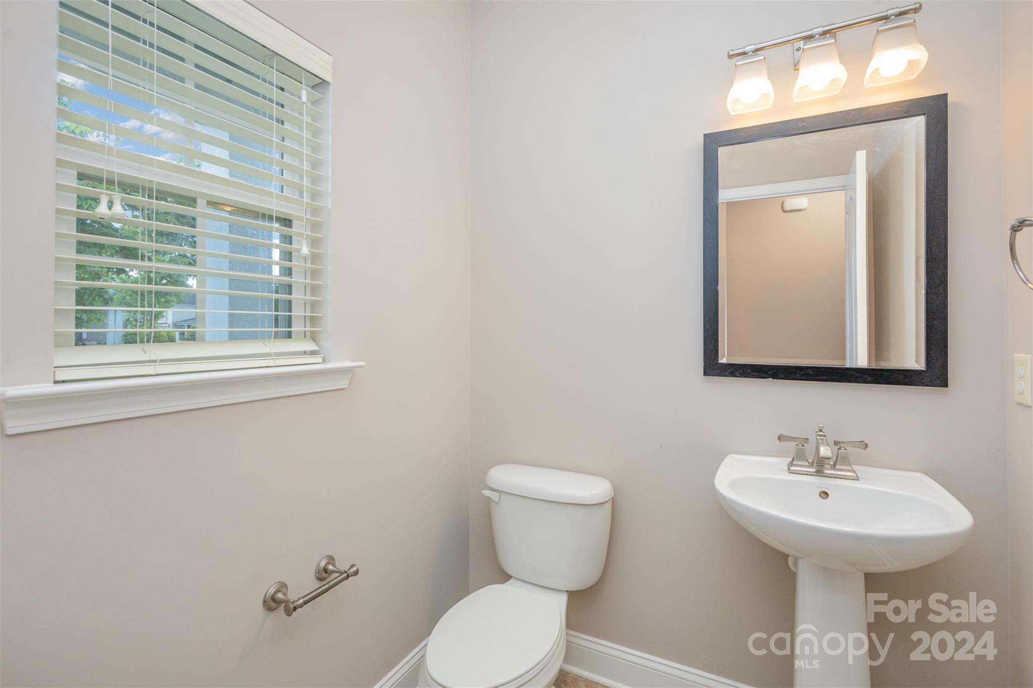 503 Waterlemon Way Monroe, NC 28110 - Photo 9 of 22 a bathroom with a toilet sink and mirror