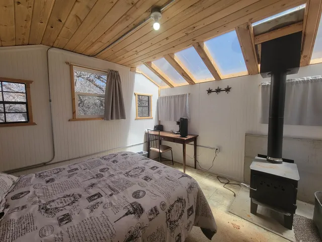 a bedroom with a bed and a table