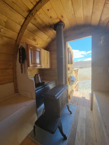 a living room with furniture and floor to ceiling windows