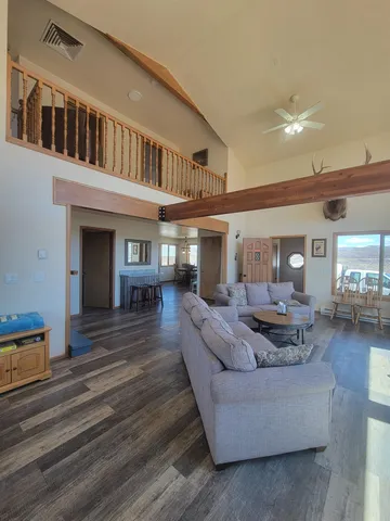 a kitchen with stainless steel appliances granite countertop a refrigerator a stove a sink dishwasher and a refrigerator with wooden floor