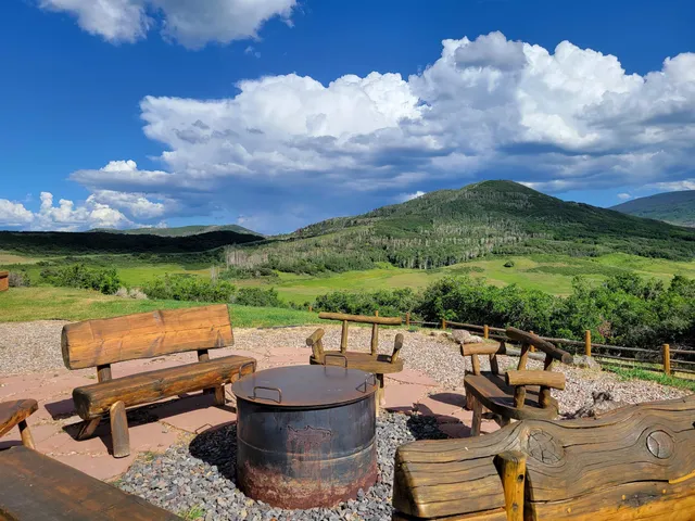 a view of a terrace with lawn chairs