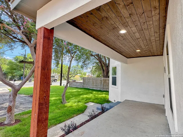 a view of a hallway with wooden floor and entryway