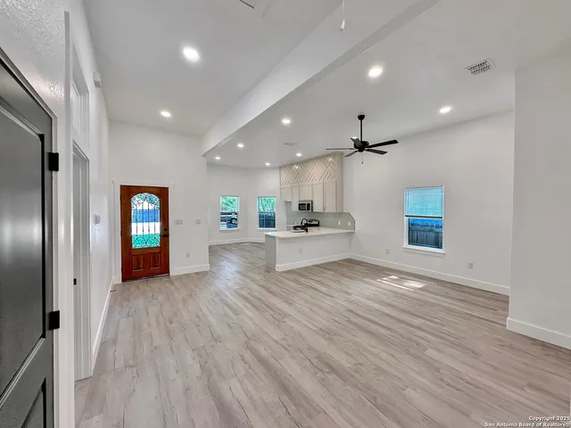a kitchen with a sink and a large mirror