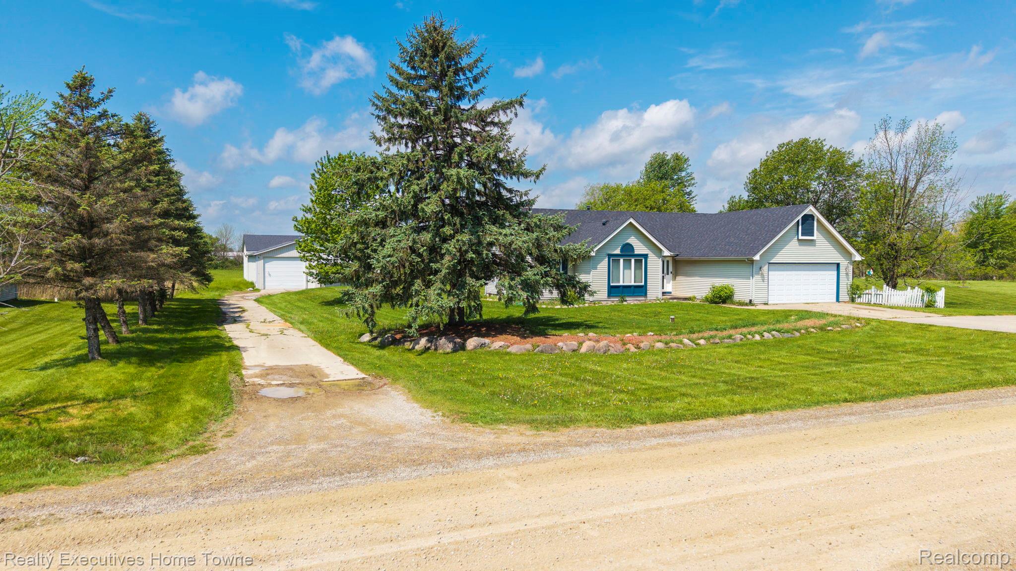 1041 Mackie Road Almont, MI 48003 - Photo 10 of 56 View of front of home with a front yard, a garage, and driveway