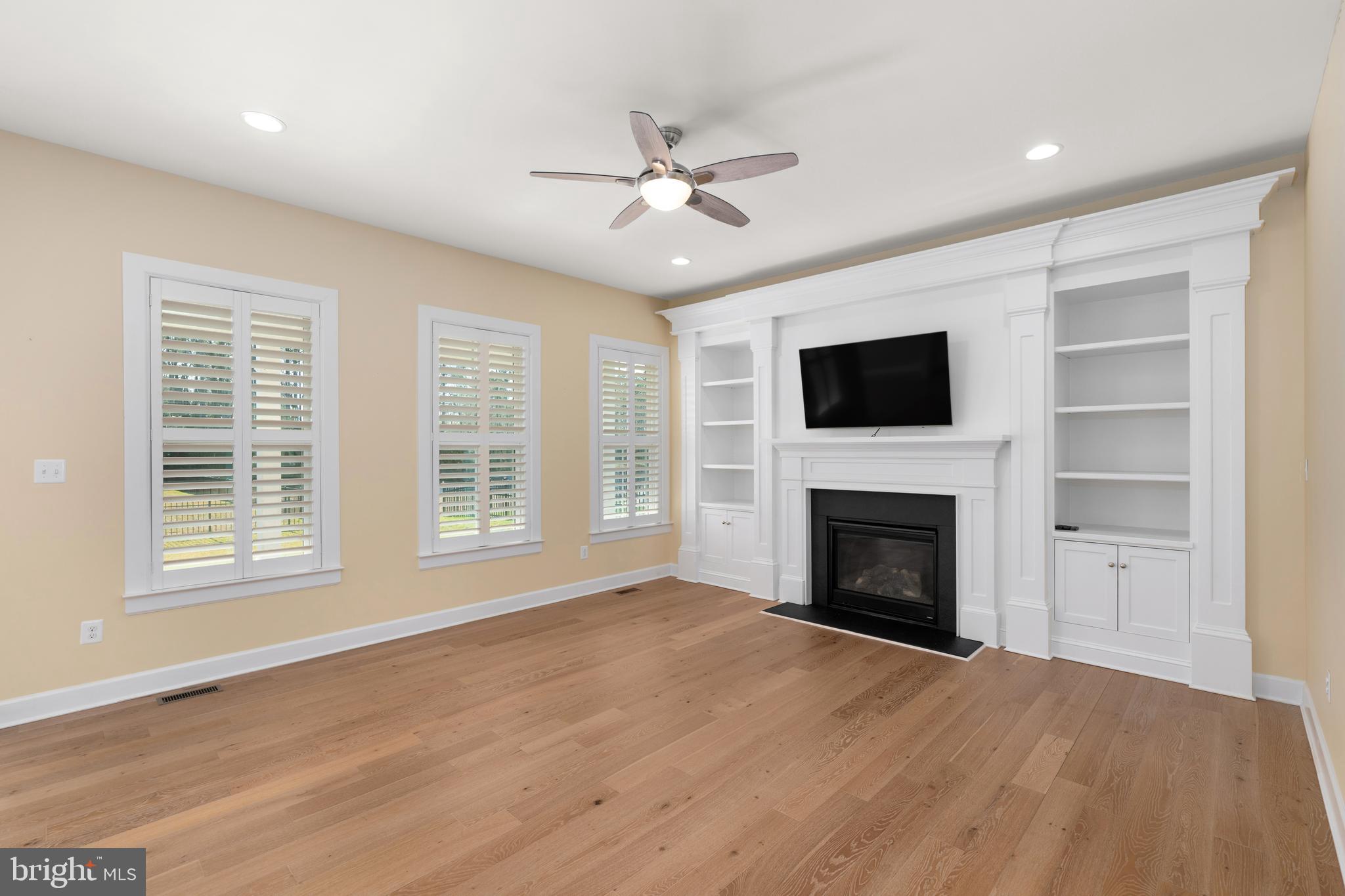 33415 Bridgehampton Lane Lewes, DE 19958 - Photo 11 of 66 a view of an empty room with a fireplace and a window