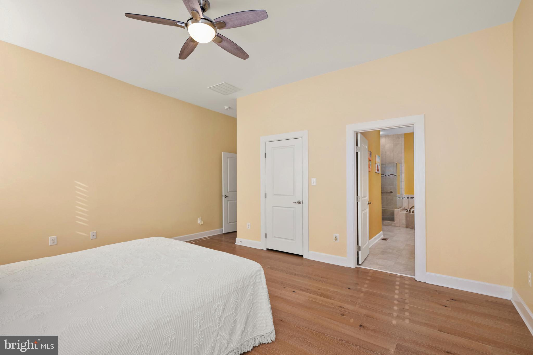 33415 Bridgehampton Lane Lewes, DE 19958 - Photo 16 of 66 a bedroom with a bed and a chandelier fan