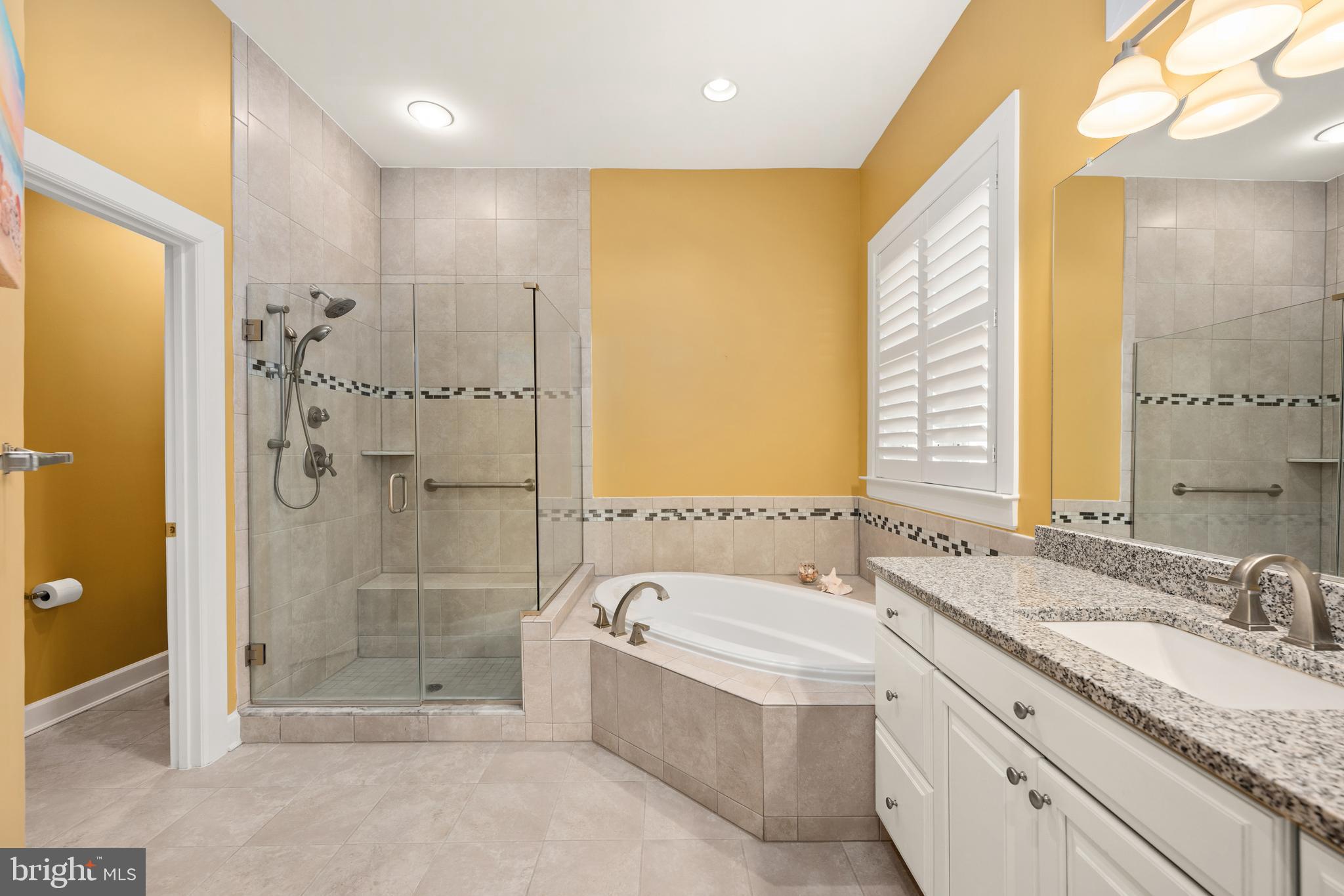 33415 Bridgehampton Lane Lewes, DE 19958 - Photo 19 of 66 a bathroom with a granite countertop bathtub shower sink and mirror