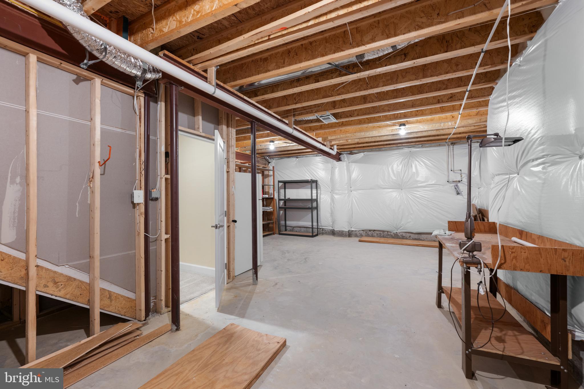 33415 Bridgehampton Lane Lewes, DE 19958 - Photo 34 of 66 a view of an empty room with wooden floor and a window