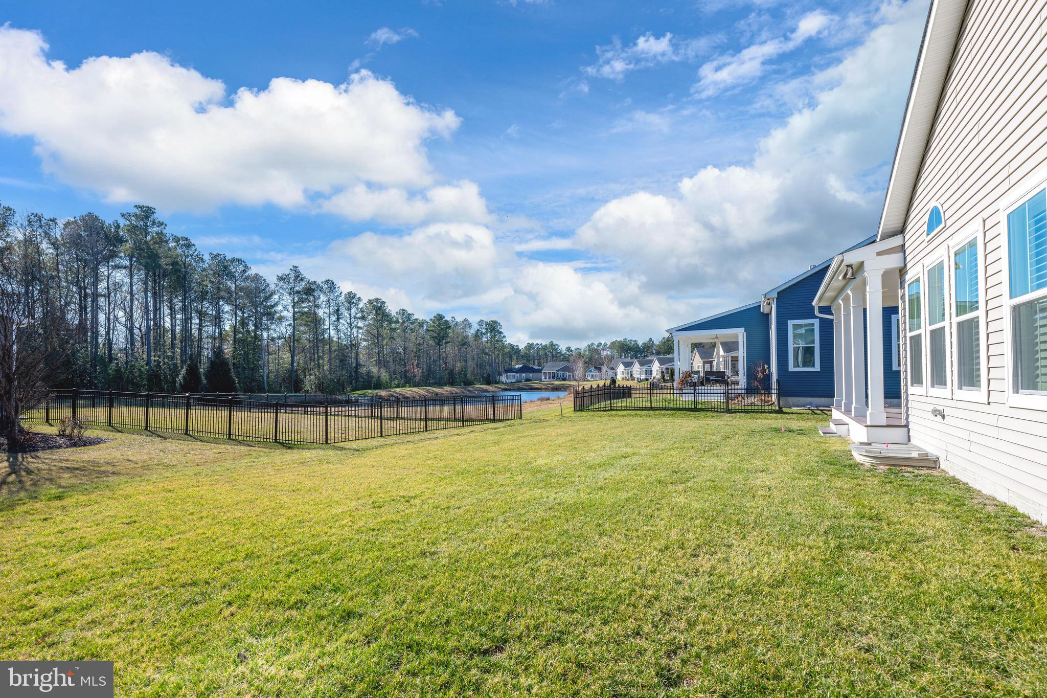 33415 Bridgehampton Lane Lewes, DE 19958 - Photo 42 of 66 a view of a swimming pool with a yard and a fountain