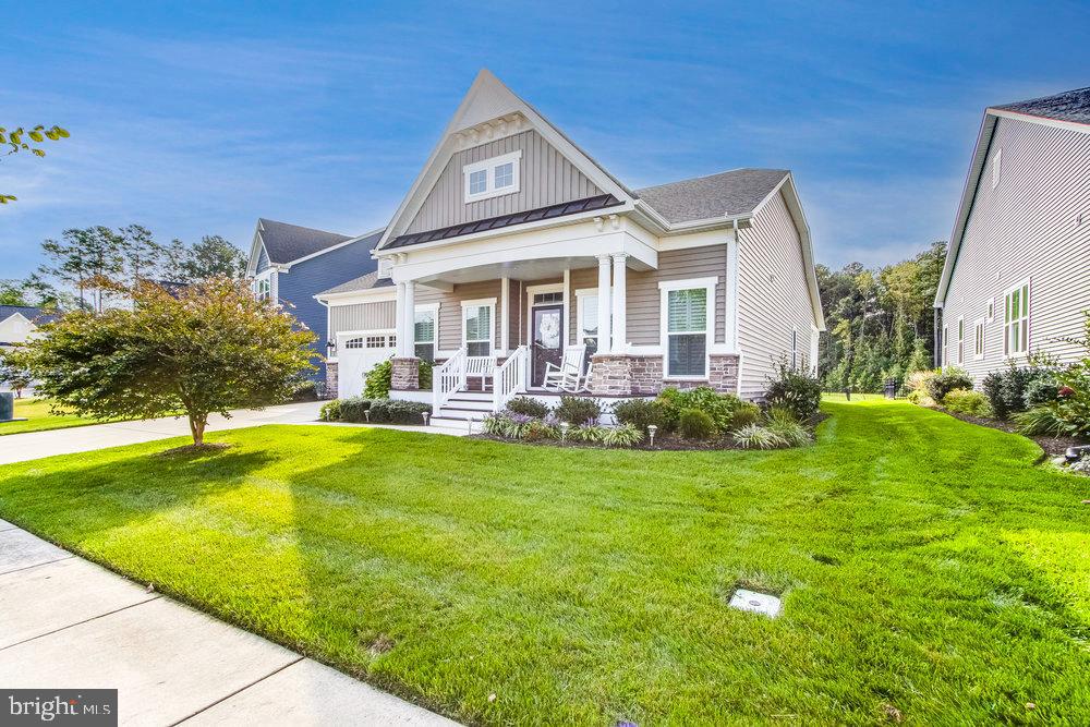 33415 Bridgehampton Lane Lewes, DE 19958 - Photo 65 of 66 a front view of a house with swimming pool having outdoor seating
