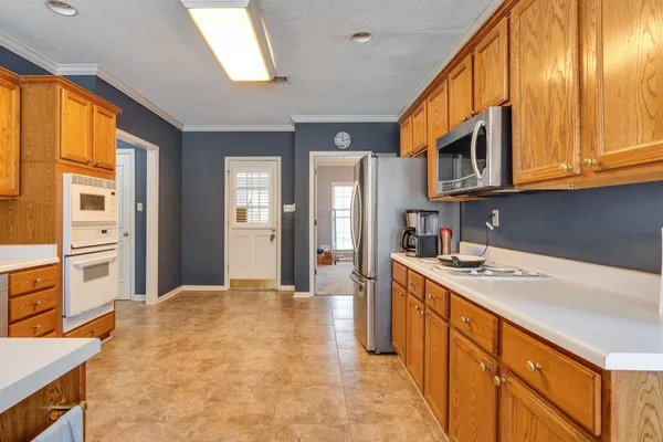 a kitchen with stainless steel appliances granite countertop a sink and cabinets