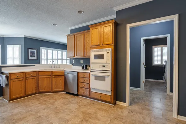 a kitchen with stainless steel appliances granite countertop a refrigerator and sink