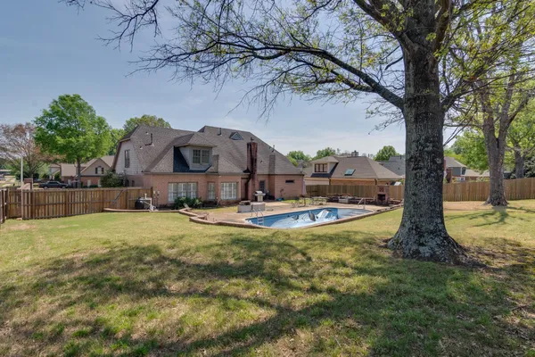 a view of pool with a yard
