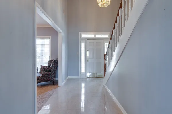 a view of a livingroom with wooden floor and furniture