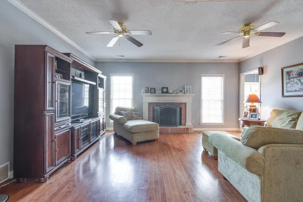 a living room with furniture fireplace and flat screen tv