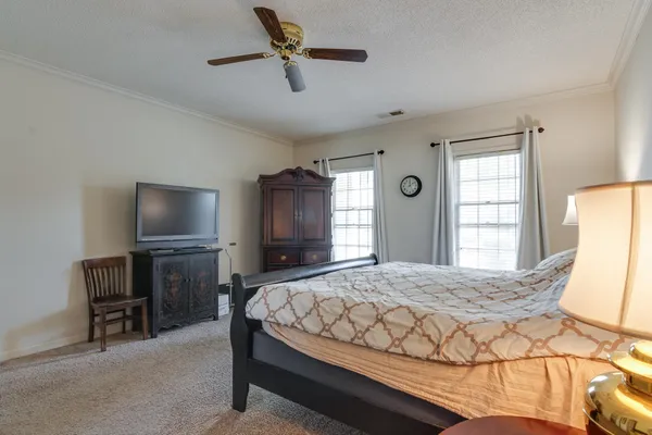 a bedroom with a bed and a television