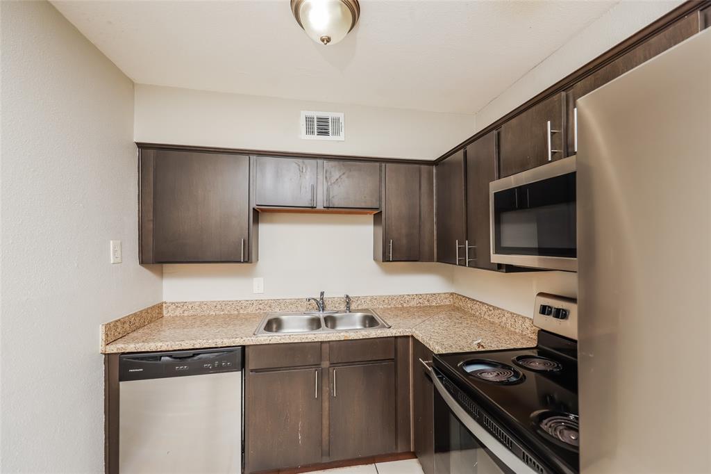 4618 Reiger Avenue, Unit 104 Dallas, TX 75246 - Photo 12 of 19 a kitchen with a stove and a microwave