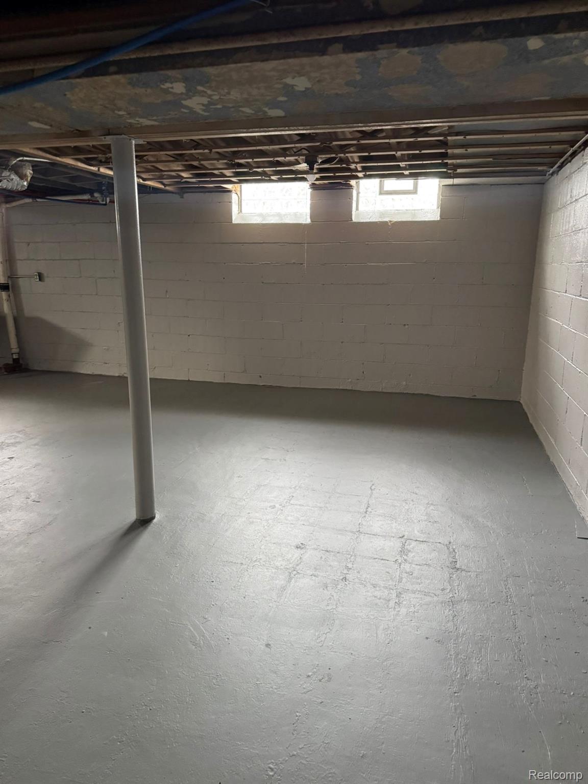 19706 Moross Road Detroit, MI 48224 - Photo 13 of 13 Unfinished basement with painted concrete block walls and painted concrete flooring