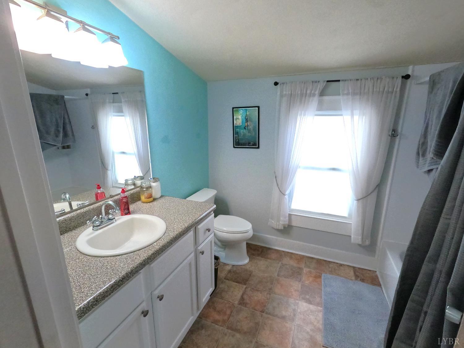 932 Bedford Road Vinton, VA 24179 - Photo 9 of 12 a bathroom with a sink toilet and mirror