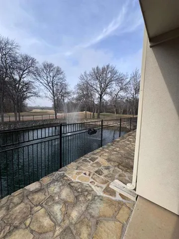 a view of a balcony with trees