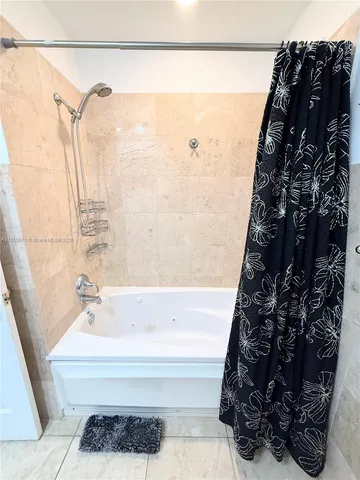a bathroom with a bathtub and shower