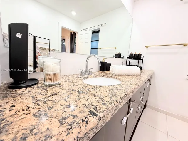 a kitchen with a sink and a refrigerator