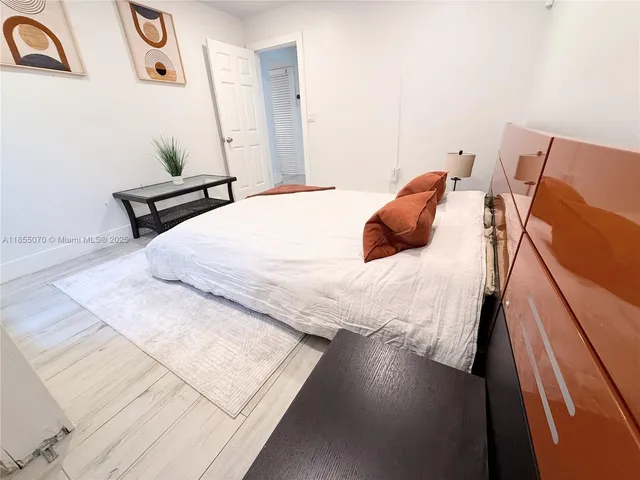 a bedroom with a bed and a night stand