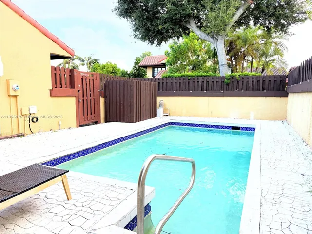 a view of swimming pool with a backyard