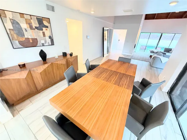 a bedroom with two beds and painting on the wall