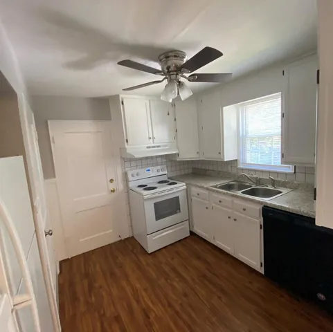 a kitchen with stainless steel appliances a white cabinets and sink