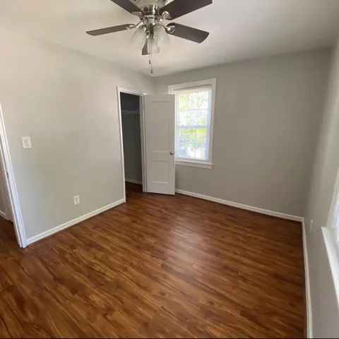 wooden floor in an empty room with a window