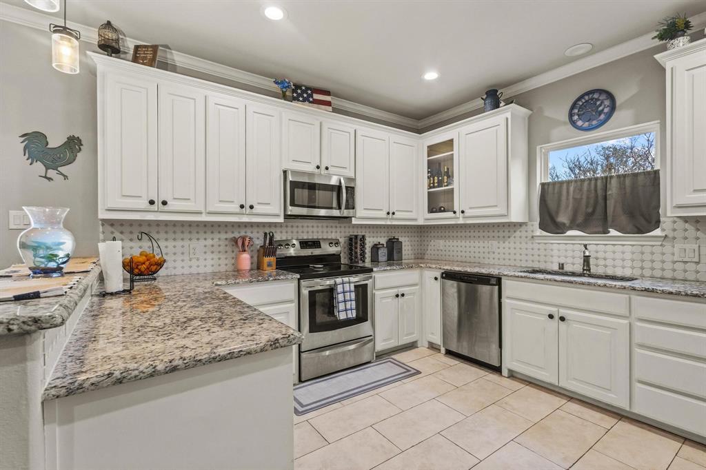 293 Redden Road Van Alstyne, TX 75495 - Photo 14 of 40 a kitchen with sink cabinets and microwave