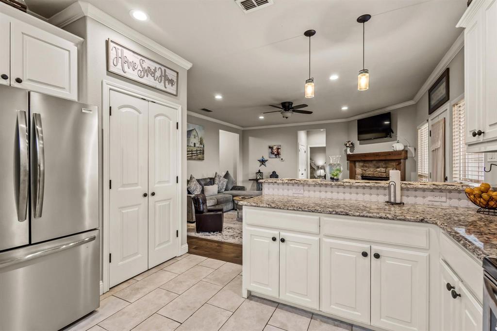 293 Redden Road Van Alstyne, TX 75495 - Photo 40 of 40 a kitchen with stainless steel appliances granite countertop a refrigerator a oven and a sink with cabinets