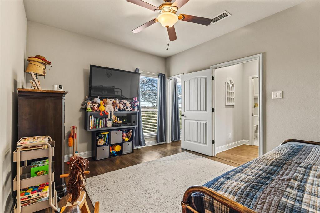 293 Redden Road Van Alstyne, TX 75495 - Photo 20 of 40 a bedroom with a bed and a chandelier