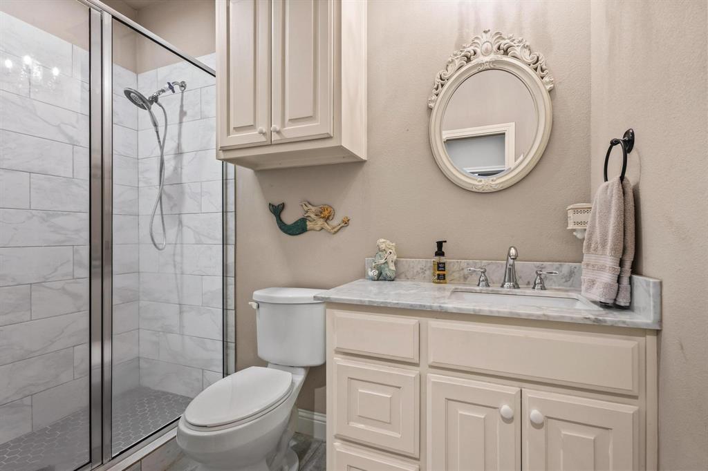 293 Redden Road Van Alstyne, TX 75495 - Photo 21 of 40 a bathroom with a granite countertop toilet sink and a mirror