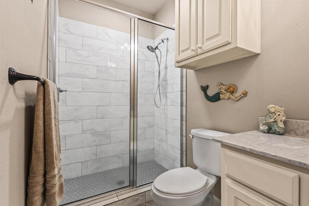 293 Redden Road Van Alstyne, TX 75495 - Photo 22 of 40 a bathroom with a granite countertop bathtub shower sink vanity and toilet