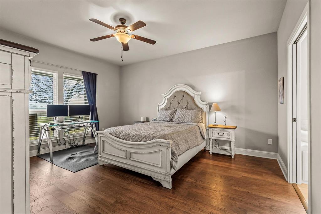 293 Redden Road Van Alstyne, TX 75495 - Photo 23 of 40 a bedroom with a bed and a chandelier