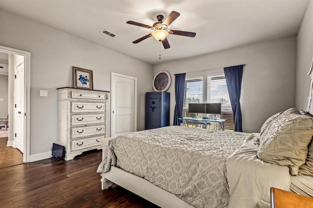 293 Redden Road Van Alstyne, TX 75495 - Photo 24 of 40 a bedroom with a bed and a dresser