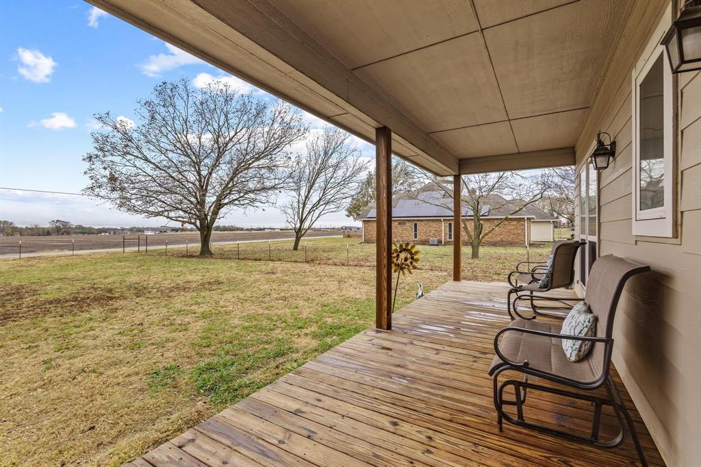 293 Redden Road Van Alstyne, TX 75495 - Photo 5 of 40 a balcony with wooden floor table and chairs