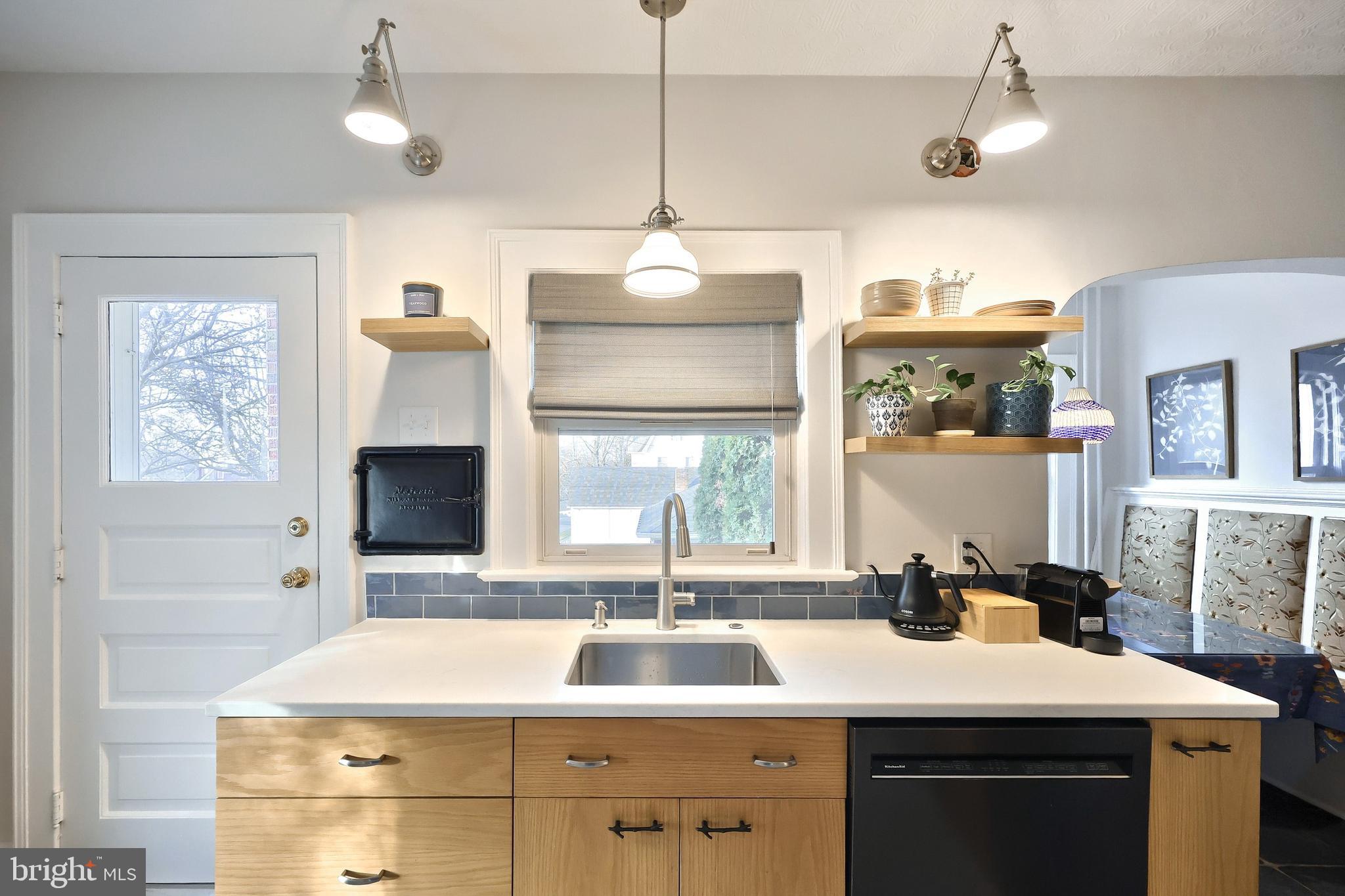 1501 3rd Avenue York, PA 17403 - Photo 18 of 40 a kitchen with a sink dishwasher a dining table and chairs with wooden floor