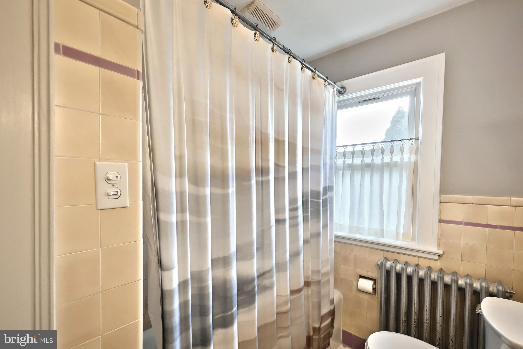1501 3rd Avenue York, PA 17403 - Photo 32 of 40 a bathroom with a window and a shower curtain