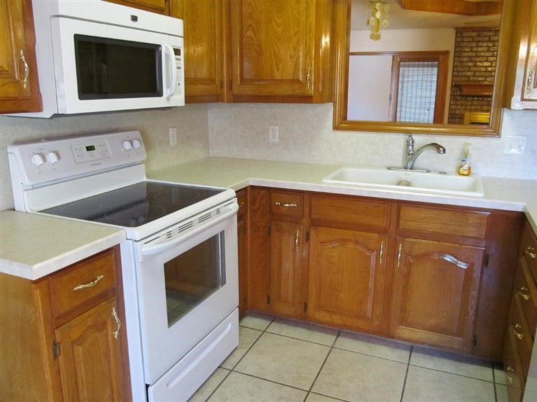 6018 73rd Street Lubbock, TX 79424 - Photo 7 of 10 a kitchen with a sink and a microwave