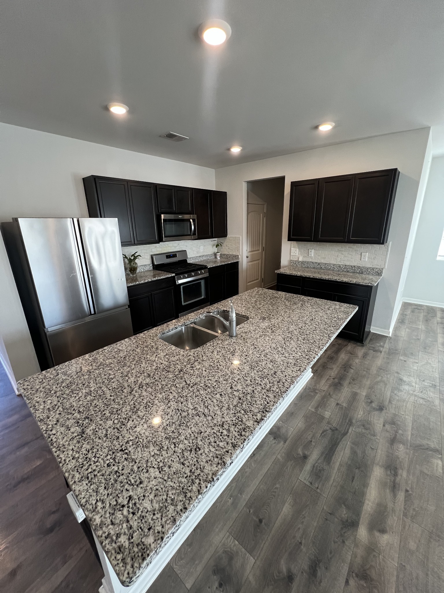 231 Tessa Grace Way Murfreesboro, TN 37129 - Photo 6 of 34 a living room with stainless steel appliances kitchen island furniture and a flat screen tv