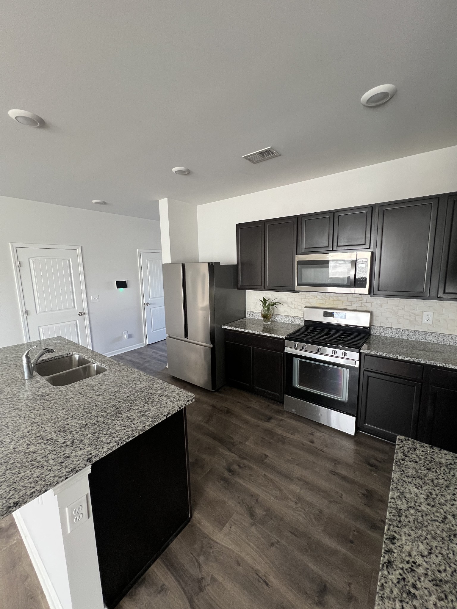 231 Tessa Grace Way Murfreesboro, TN 37129 - Photo 7 of 34 a kitchen with granite countertop a stove and cabinets