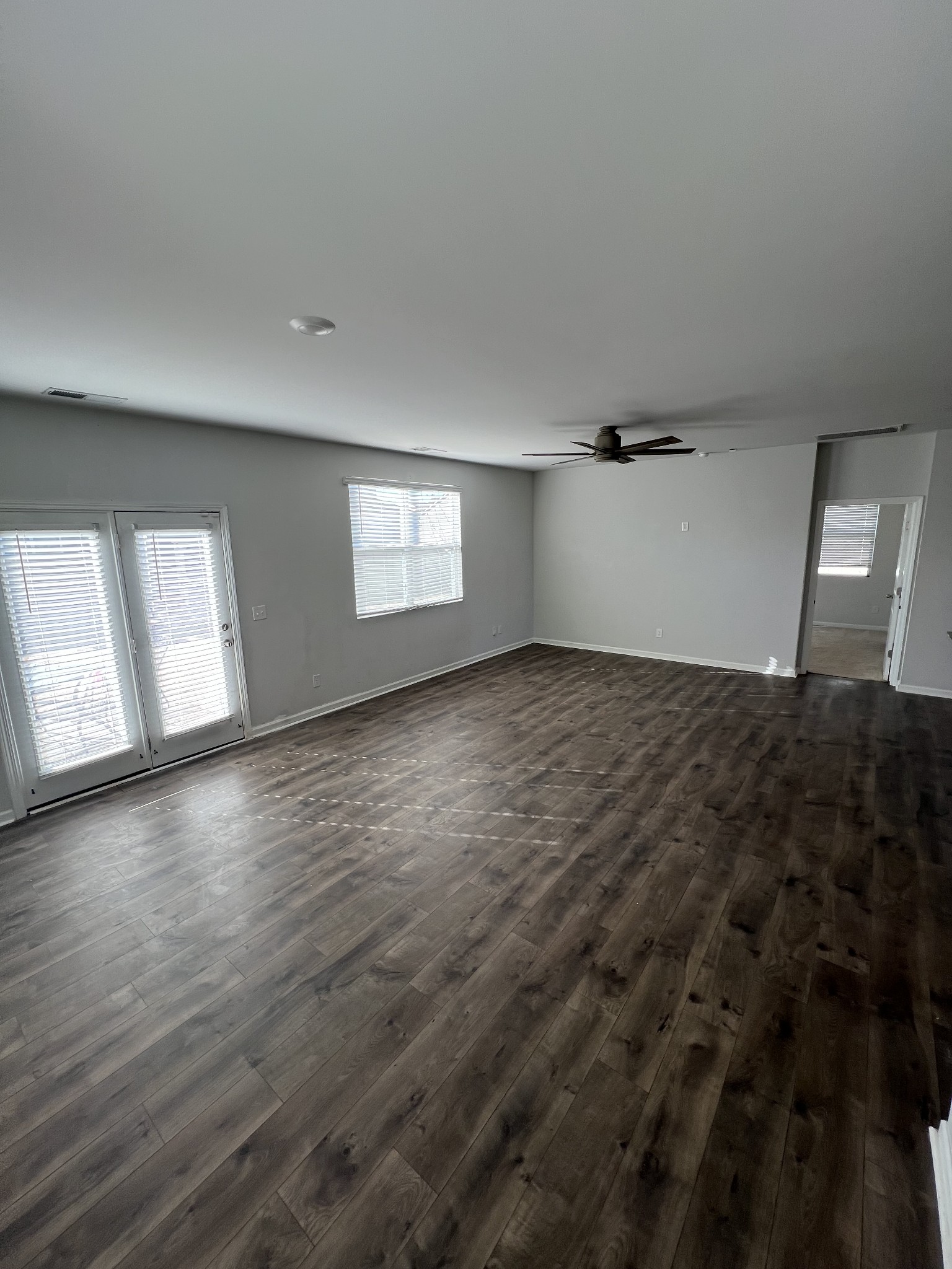 231 Tessa Grace Way Murfreesboro, TN 37129 - Photo 10 of 34 an empty room with wooden floor and windows