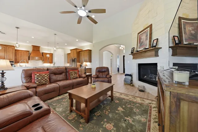 a kitchen with stainless steel appliances granite countertop a sink refrigerator and cabinets