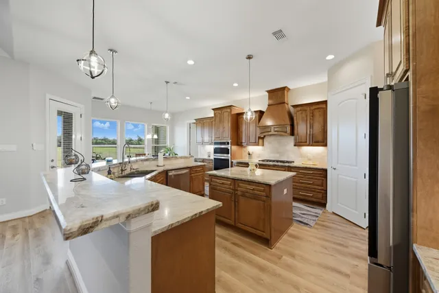 a large kitchen with a table and chairs in it