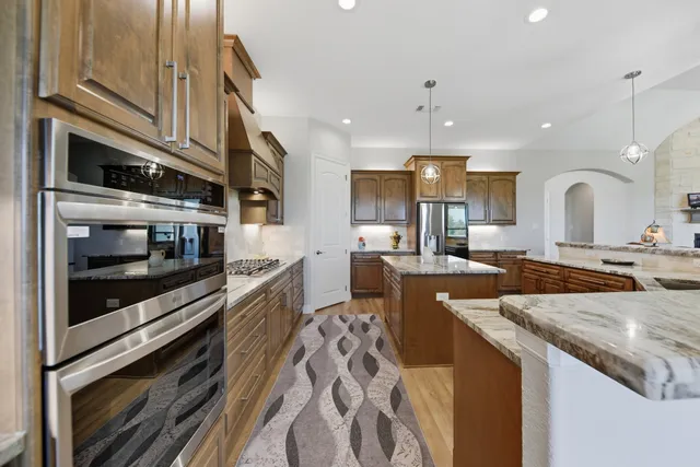 a spacious bedroom with a large bed and a chandelier