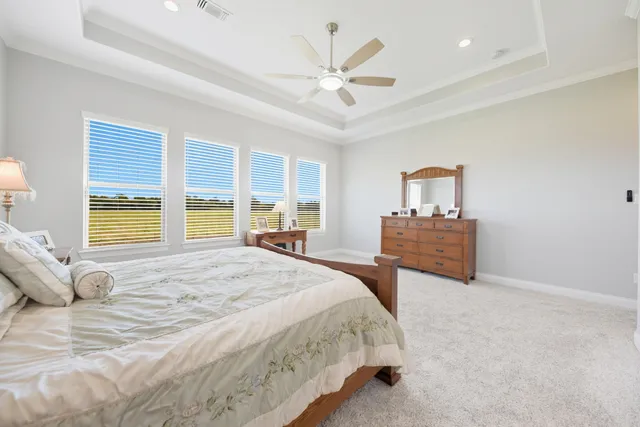 a spacious bedroom with a bed and a cabinets